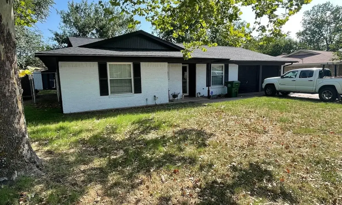Professional roofing crew working on a residential roof in Swanzey